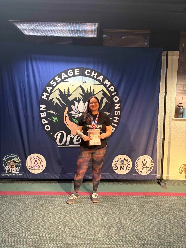 Kacie Hinojosa with her award at the Open Massage Championship, Oregon